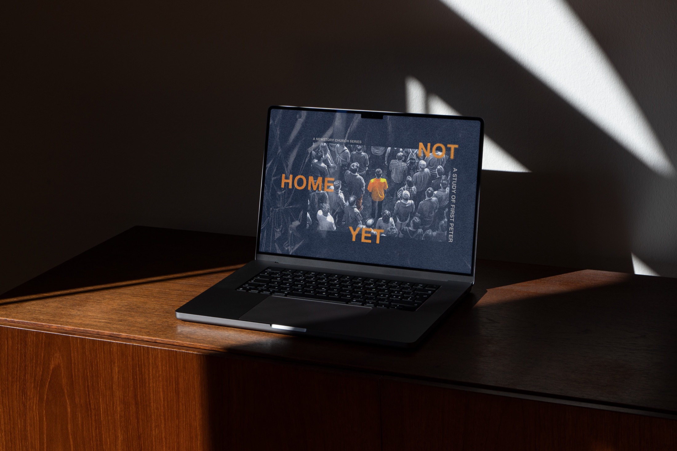 Not Home Yet series graphic displayed on a laptop